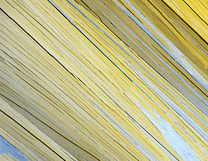Abstract close-up of yellow and gray textured lines creating a dynamic, layered pattern.
