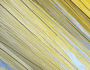 Abstract close-up of yellow and gray textured lines creating a dynamic, layered pattern.