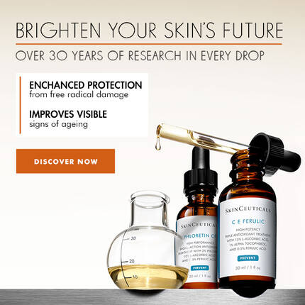 A skincare advertisement featuring two serum bottles and a measuring flask. The text emphasizes enhanced protection from free radical damage and improved signs of aging, encouraging viewers to discover more.