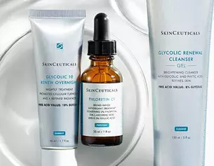 Three Skinceuticals skincare products displayed: a cleanser, serum, and overnight treatment, highlighting their sleek packaging.