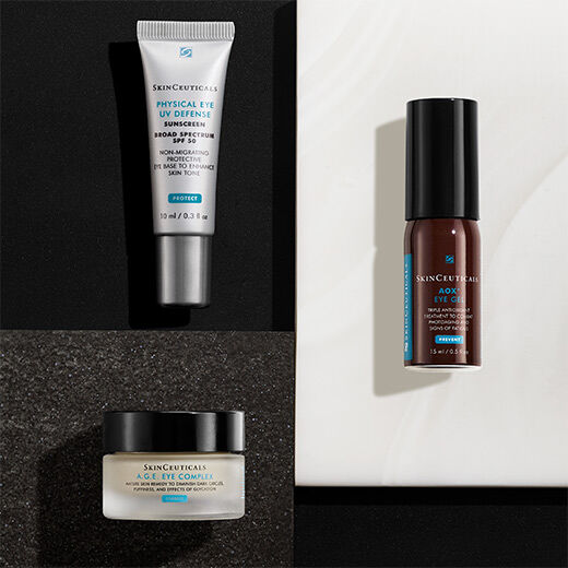 A close-up of two skincare products: a tube of Physical Eye UV Defense sunscreen with SPF 50 and a bottle of SkinCeuticals AOX Eye Gel. Both are designed for eye protection and enhancement.
