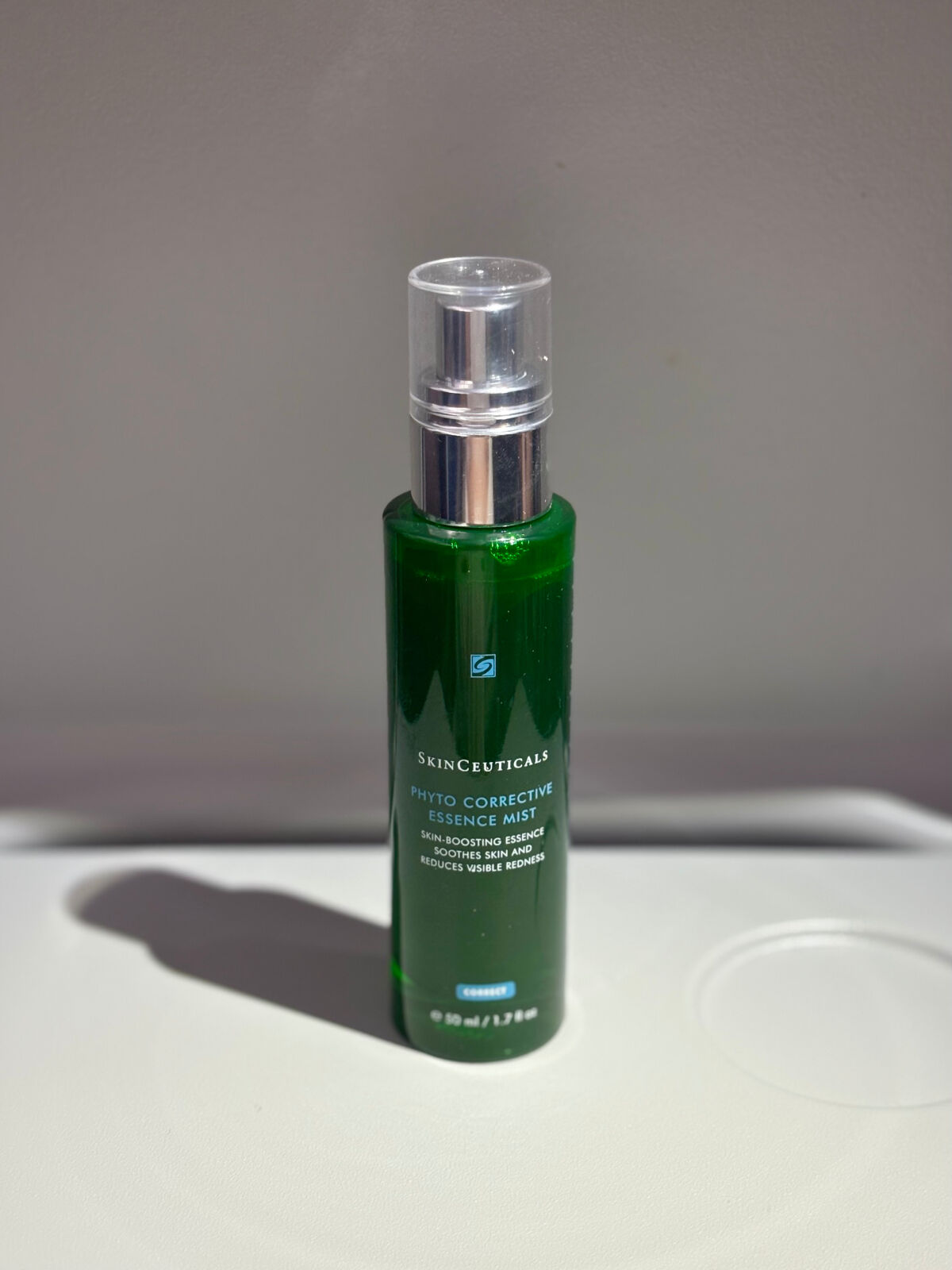 A bottle of Skinceuticals Phyto Corrective Essence Mist on a neutral background, designed for soothing and hydrating skin.