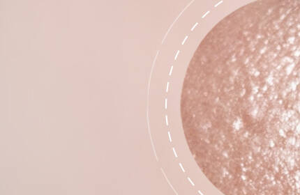 A smooth, textured close-up of a skin surface with a soft, neutral background.
