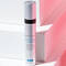 A silver tube of Antioxidant Lip Repair from a skincare brand, positioned against a backdrop of white and pink geometric shapes.