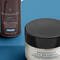 Three skincare products from SkinCeuticals displayed against a blue background: AOX Eye Gel, A.G.E. Eye Complex, and Mineral Eye UV Defense SPF 30.