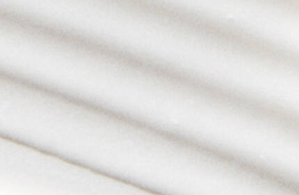 Abstract close-up of smooth, wavy white lines creating a soft, textured pattern.