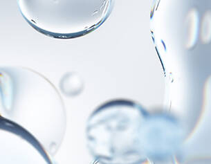 Abstract close-up of clear water droplets with soft reflections against a light background.