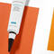 Two tubes of skincare products are positioned on a background of orange and white paper. One tube is labeled "Retinol 0.3" and features a black tip, while the other, smaller tube also displays the brand name "Skinceuticals."