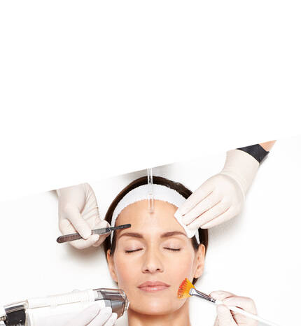A serene woman receives a facial treatment with multiple skincare tools being applied to her face.
