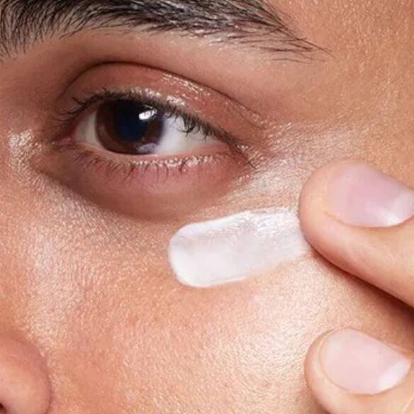 Close-up of skin with visible freckles and uneven texture.