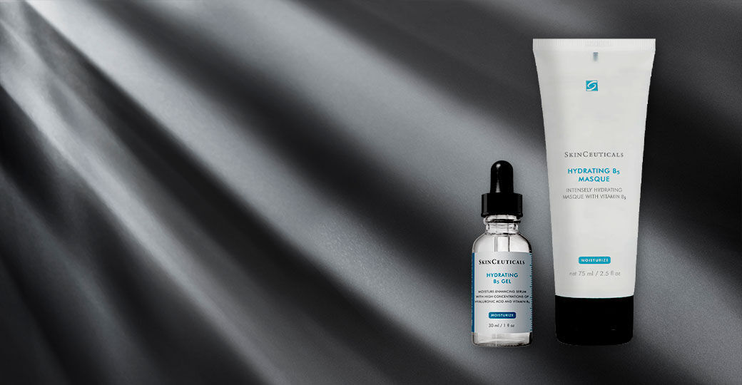 A product display featuring two skincare items: a dropper bottle of hydrating serum and a tube of hydrating mask, both against a dark, softly illuminated background.