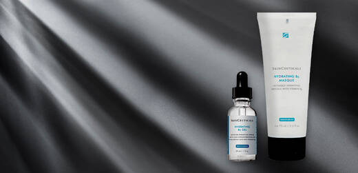 A product display featuring two skincare items: a dropper bottle of hydrating serum and a tube of hydrating mask, both against a dark, softly illuminated background.