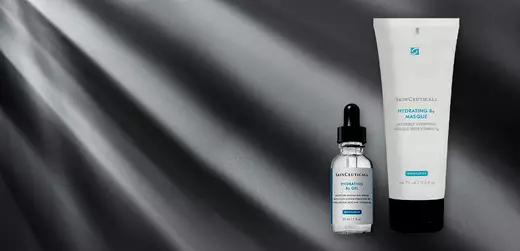 A product display featuring two skincare items: a dropper bottle of hydrating serum and a tube of hydrating mask, both against a dark, softly illuminated background.