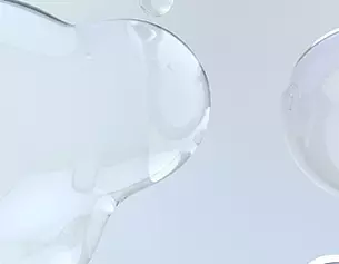 Abstract close-up of translucent gel blobs against a light background, showcasing smooth textures and reflections.