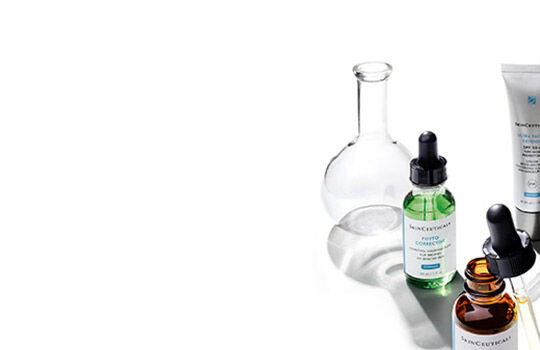 Alt text: A collection of glass vials and droppers containing various colored liquids, arranged on a white background.