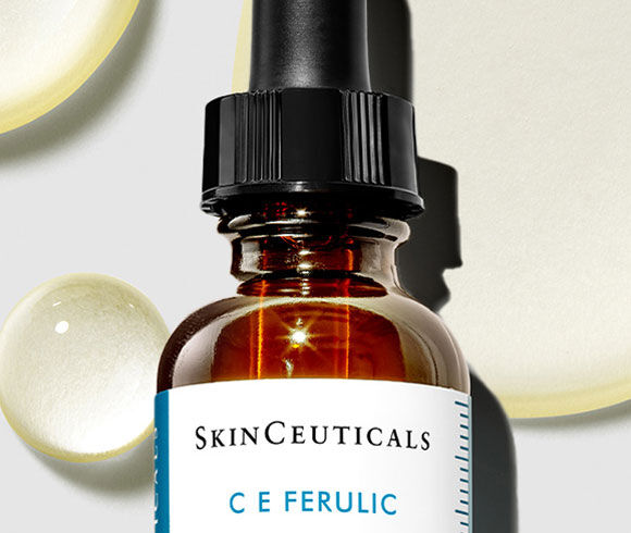 SkinCeuticals C E Ferulic Vitamin C Serum with yellow droplets behind