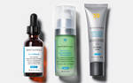 Three SkinCeuticals skincare products: a vitamin C serum, a brightening moisturiser, and a high-SPF sunscreen.