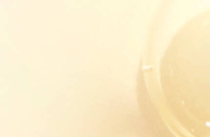 Abstract image featuring softly glowing translucent bubbles against a light beige background.