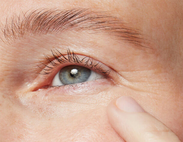 Close up of a mature woman resting a finger on her cheek