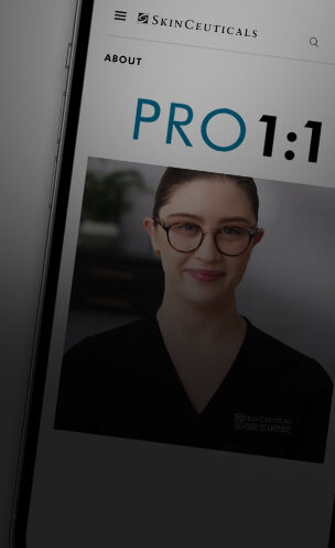 A woman in a black uniform smiles, displaying a skincare program titled PRO 1:1 on a digital device screen