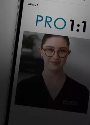 A woman in a black uniform smiles, displaying a skincare program titled PRO 1:1 on a digital device screen