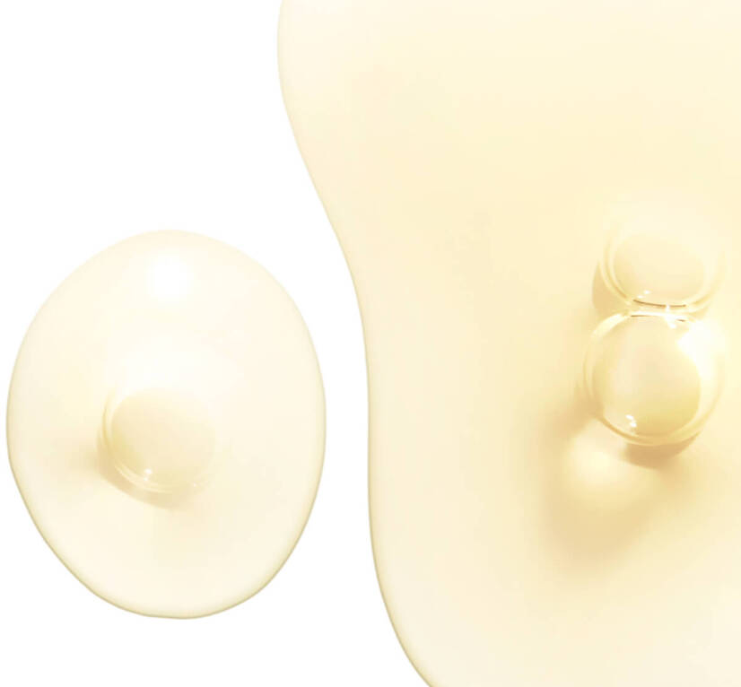 Two blobs of translucent, pale yellow liquid, one larger and irregularly shaped, the other smaller and round.