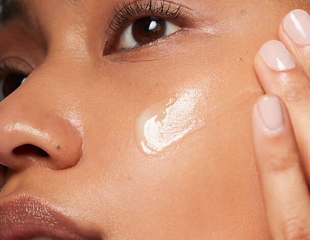 Woman applying SkinCeuticals Retinol 0.3 to her cheek