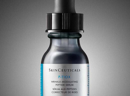 Serum bottle with dropper on a minimalist background, highlighting its sleek and modern design.