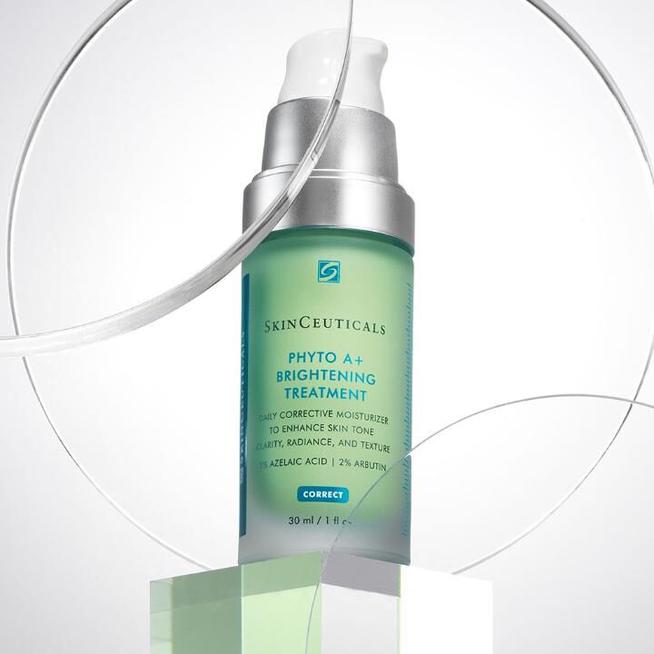 A bottle of SkinCeuticals Phyto A+ Brightening Treatment on a geometric pedestal, highlighting its skincare benefits.