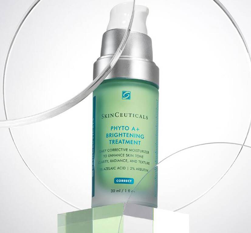 A bottle of SkinCeuticals Phyto A+ Brightening Treatment on a geometric pedestal, highlighting its skincare benefits.