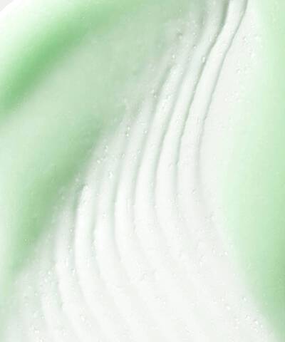 Close up texture shot of Phyto A+ Brightening Treatment – a pale green moisturiser with a raked effect running through