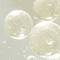 Close-up image of Niacinamide skincare ingredient. Light, bubbly liquid with a soft champagne color.