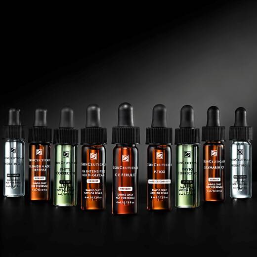 A bottle of SkinCeuticals C E Ferulic serum is featured against a dark background, with dynamic red and gray abstract shapes surrounding it, highlighting its 20-year anniversary.