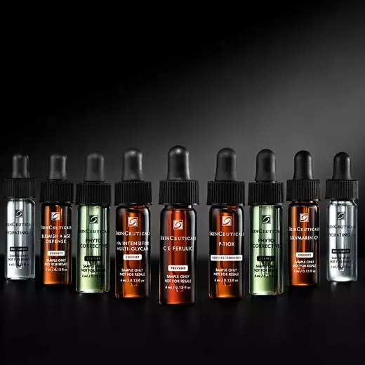 A bottle of SkinCeuticals C E Ferulic serum is featured against a dark background, with dynamic red and gray abstract shapes surrounding it, highlighting its 20-year anniversary.